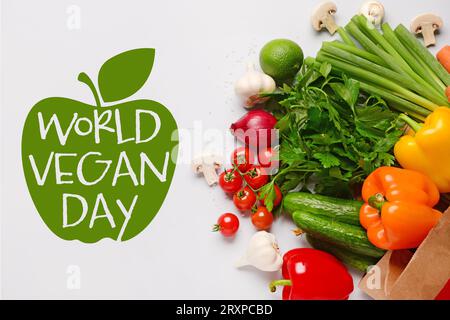 Greeting card for World Vegan Day with many vegetables on light background Stock Photo