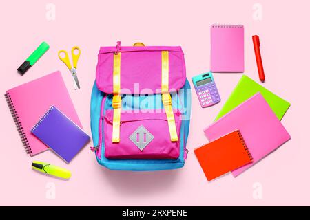 Stylish school backpack with different stationery on pink background Stock Photo