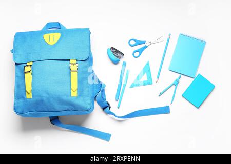 Stylish school backpack and different stationery on white background Stock Photo