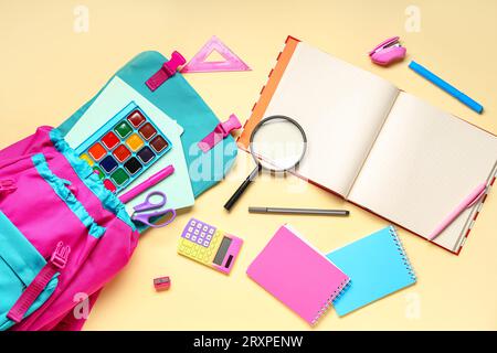 Composition with stylish school backpack and different stationery on color background Stock Photo