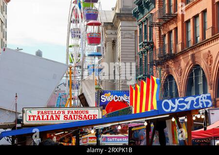 Amusement rides, carnival games, Italian sausage and peppers, oysters, and more at the San Gennaro Feast street fair in Little Italy, New York City. Stock Photo