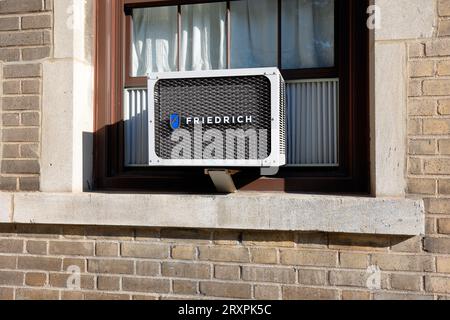 A Friedrich air conditioner. friedrich air conditioning unit mounted in a window. Stock Photo