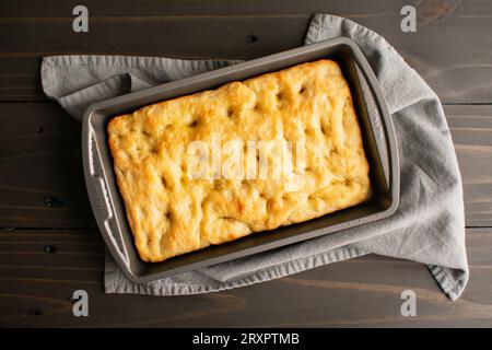 Freshly Baked Focaccia Bread in a Shallow Pan: Freshly baked Italian peasant bread in a metal baking pan Stock Photo