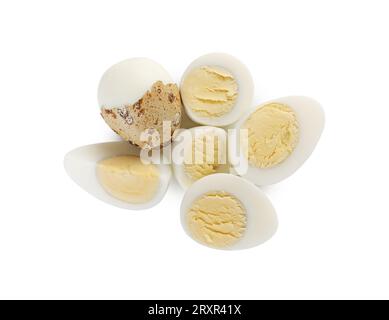 Peeled hard boiled quail eggs and another one partly in shell on white background, top view Stock Photo