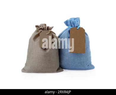 Tied burlap bags with tags isolated on white Stock Photo