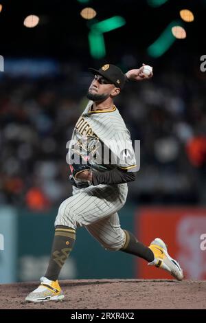San Diego Padres' Robert Suarez taps his chest as he walks to the dugout in  the eighth inning of a baseball game against the Texas Rangers Sunday, July  30, 2023, in San