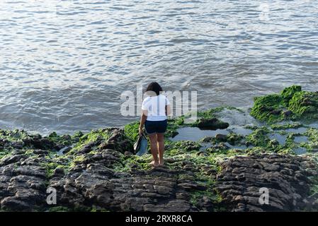 Salvador, Bahia, Brazil - December 31, 2021: Faithful Candomble people are seen taking gifts to Iemanja on Rio Vermelho beach in the city of Salvador, Stock Photo