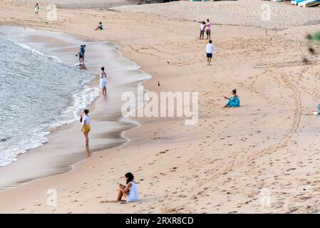 Salvador, Bahia, Brazil - December 31, 2021: Faithful Candomble people are seen taking gifts to Iemanja on Rio Vermelho beach in the city of Salvador, Stock Photo