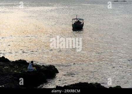 Salvador, Bahia, Brazil - December 31, 2021: Faithful Candomble people are seen taking gifts to Iemanja on Rio Vermelho beach in the city of Salvador, Stock Photo