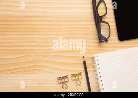 wood desk office with laptop, smartphone and other work supplies with cup of coffee. Top view with copy space for input the text. Designer workspace o Stock Photo