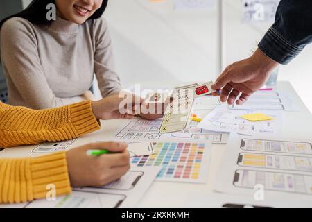 team of UI UX web designer are working together to develop mobile responsive websites with UI UX front end designer previews Stock Photo