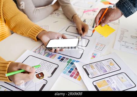 team of UI UX web designer are working together to develop mobile responsive websites. Mobile Mockup Stock Photo