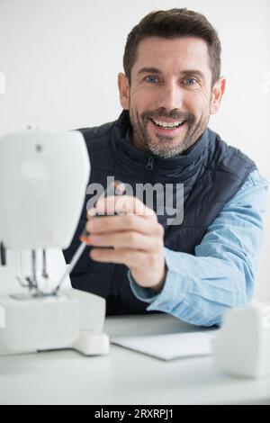 man repairing a sewing machine Stock Photo