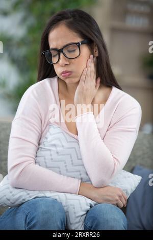 sad depressed thoughtful young woman feeling bad at home Stock Photo