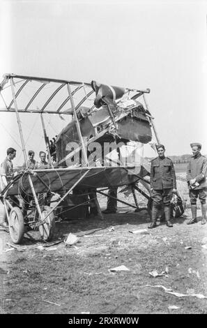 British soldiers stand guard by a crashed enemy aircraft during the First World War. Stock Photo