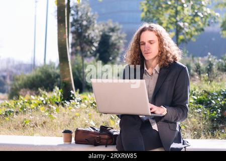 modern businessman working outdoors with a laptop Stock Photo