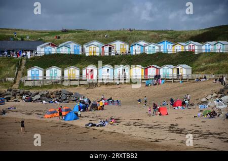 Beach huts and sand at Bude holiday town on north Cornwall coast, UK Stock Photo