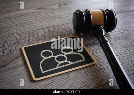 Closeup image judge gavel and chalkboard with family icon. Guardianship, family law concept. Stock Photo