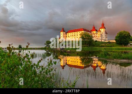Lacko Castle and the reflection in the water at sunset, Kallandso island, Vanern lake, Vastra Gotaland, Sweden, Scandinavia, Europe Stock Photo