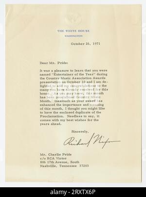 Letter from Richard Nixon to Charley Pride on the occasion of Pride winning Entertainer of the Year by the Country Music Association.  The letter is written on White House letterhead with an embossed seal at the top.  It is signed by Richard Nixon in black ink. Letter is framed within a black frame and a cream colored paper mat with a black border.  The back of the frame has a small price sticker in the upper right hand corner. Stock Photo