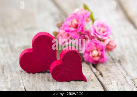 kalanchoe flower and hearts on wooden background Stock Photo