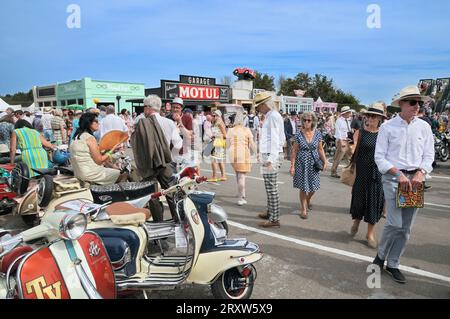 The famous Goodwood Revival festival, Chichester, West Sussex, England, UK. People visiting Revival High Street with its set of period themed shops. Stock Photo