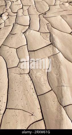 Abstract pattern of dry cracked clay mud surface, dried riverbed caused by prolonged drought. Swakop river, Namibia, Africa Stock Photo