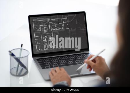 Architect designer using laptop and stylus while working in office Stock Photo