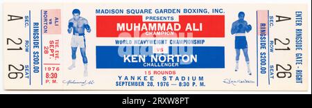 Ticket to the World Heaveywieght Championship boxing match between Muhammad Ali and Ken Norton. The ticket is white with red, blue and black text. The text appears both horizontally and vertically on the ticket. Pictured in blue ink on the left side of the ticket is Muhammad Ali standing with his boxing gloves raised. Pictured in blue ink on the right side of the ticket is Ken Norton with his boxing gloves raised. The text at center begins 'MADISON SQUARE GARDEN BOXING, INC. / PRESENTS / MUHAMMAD ALI / CHAMPION...' Stock Photo