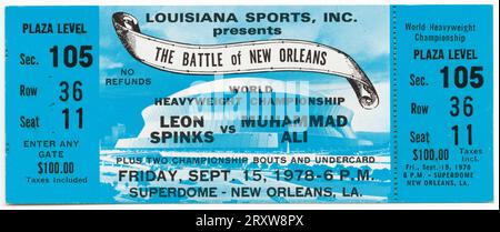 Ticket to the World Heaveywieght Championship boxing match between Muhammad Ali and Leon Spinks. The ticket is blue with black text. An image of the Superdome can be seen on the ticket. The text on the ticket starts with 'LOUISIANA SPORTS, INC. / PRESENTS / THE BATTLE of NEW ORLEANS...' Stock Photo