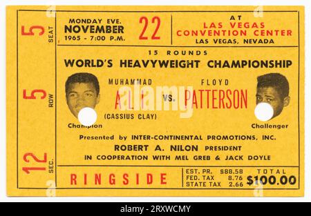 Yellow admission ticket for boxing match between Champion Muhammad Ali and Challenger Floyd Patterson (photo portraits visible next to names). Red and black all Caps typeface throughout the ticket Stock Photo