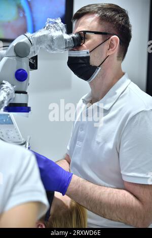 Doctor does the operation with a microscope. Medical Inovation Concept. Close Up Stock Photo