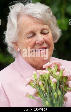 Portrait of a cheerful female senior - John Gollop Stock Photo
