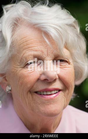 Portrait of a cheerful female senior - John Gollop Stock Photo