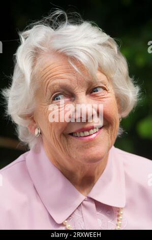 Portrait of a cheerful female senior - John Gollop Stock Photo