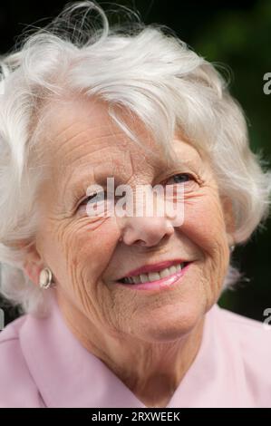Portrait of a cheerful female senior - John Gollop Stock Photo