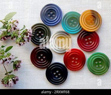 A sample of buttons with small flowers on a table Stock Photo