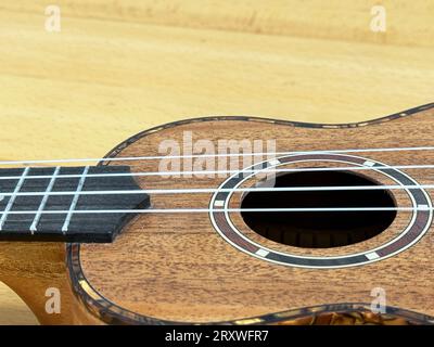 Close up of a soprano ukulele on a wooden surface. Stock Photo
