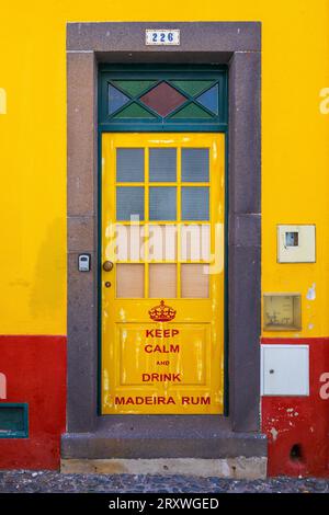Beautiful view of a painted door located in the Santa Maria Maior historical district, Funchal, Madeira, depicting "Keep Calm and Drink Madeira Rum" Stock Photo
