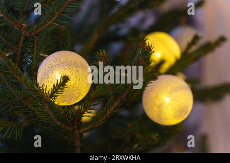 Ball shaped lights on christmas tree, close up Stock Photo