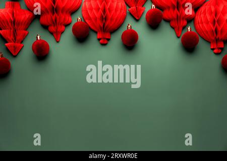 Christmas or New Year background. Green color flat lay with red burgundy decorations. Copy space for advertising or marketing text. Paper balls and fi Stock Photo