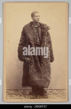 Cabinet card of Buffalo soldier wearing buffalo coat ca. 1886 Stock Photo