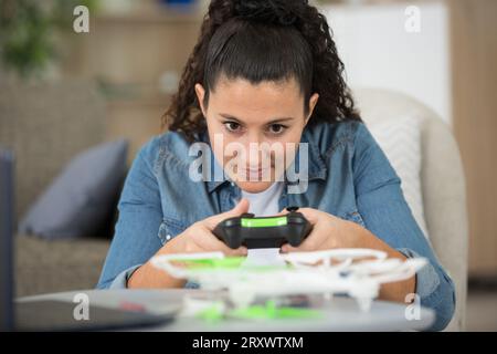 woman in the home controlling drone remotely Stock Photo