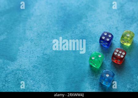 set of colorful dice on a blue watercolor background Stock Photo