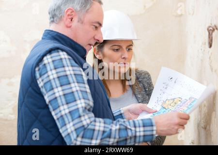 architect on site discussing plans with builder Stock Photo