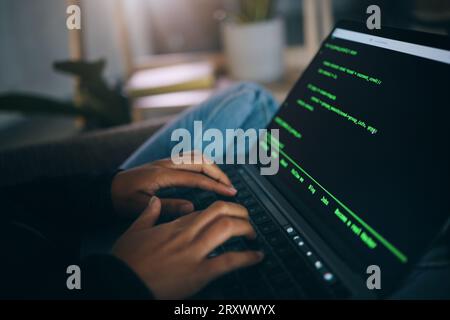 Developer hands, code overlay and laptop typing with cybersecurity, hacker and data analysis. Person, programmer and computer work with firewall Stock Photo