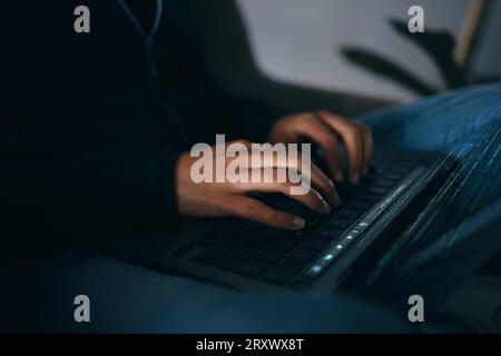 Hacker, hands typing on laptop and information technology for coding and database with phishing and cyber crime. Cybersecurity, person programming or Stock Photo