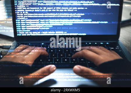 Hands, code overlay and laptop typing with cybersecurity, hacker and software data analysis. Person, programmer and computer work with firewall system Stock Photo
