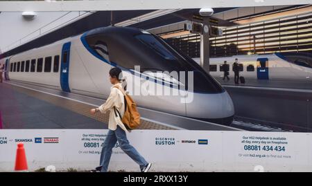 London, UK. 27th September 2023. A pedestrian passes by the HS2 construction site at Euston Station. The High Speed 2 railway line continues to be beset with problems as reports emerge that the government may cut the route from Birmingham to Manchester due to spiralling costs. Credit: Vuk Valcic/Alamy Live News Stock Photo