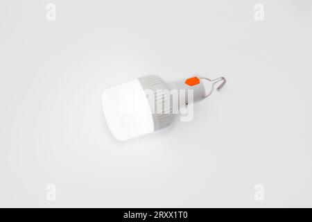 LED lamp with USB charging on a white background. Source of energy saving. Electricity conservation concept Stock Photo